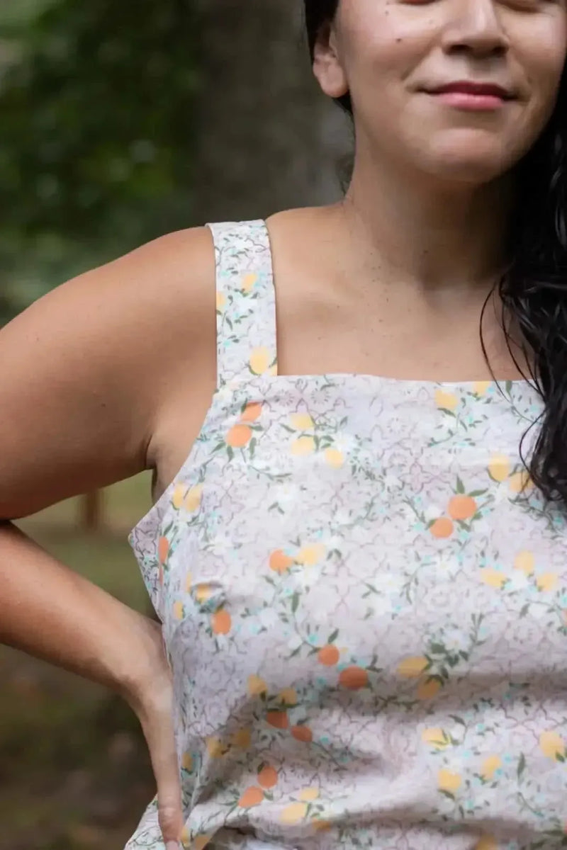 A woman wears a top made from Moroccan Citrus fabric, featuring oranges and lemons.