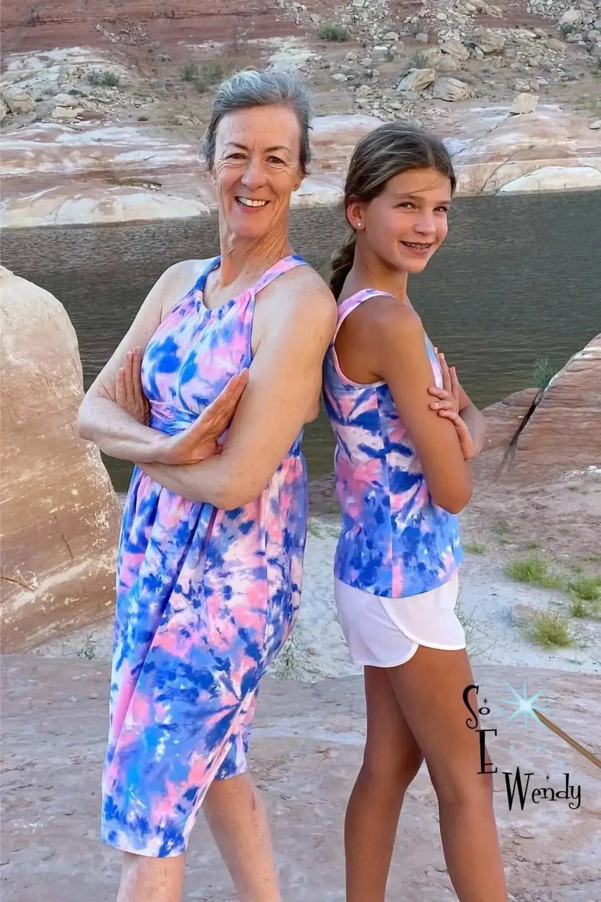 Two women wear garments made from bubblegum tie-dye fabric in pink and blue.
