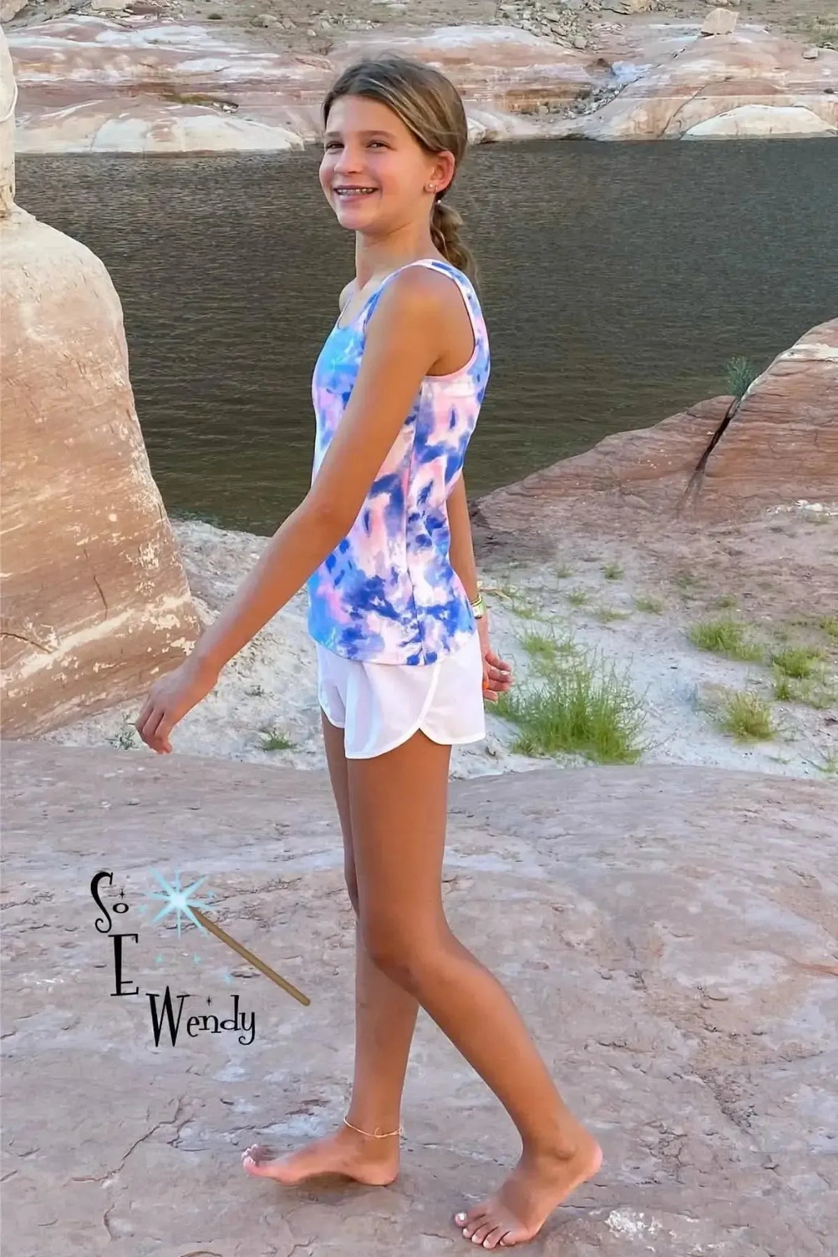 Vibrant pink and blue bubblegum tie-dye print fabric shown in a girl's tank top and shorts.