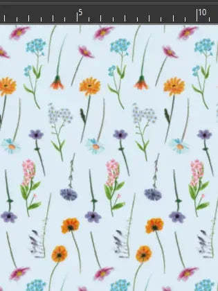 A light blue fabric with a repeating pattern of various colorful wildflowers.