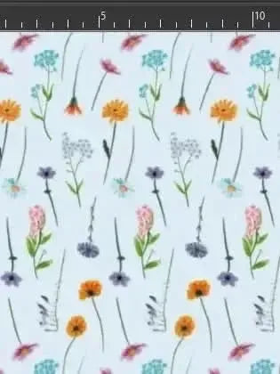Light blue fabric printed with scattered wildflowers in pink, orange, purple, and blue.