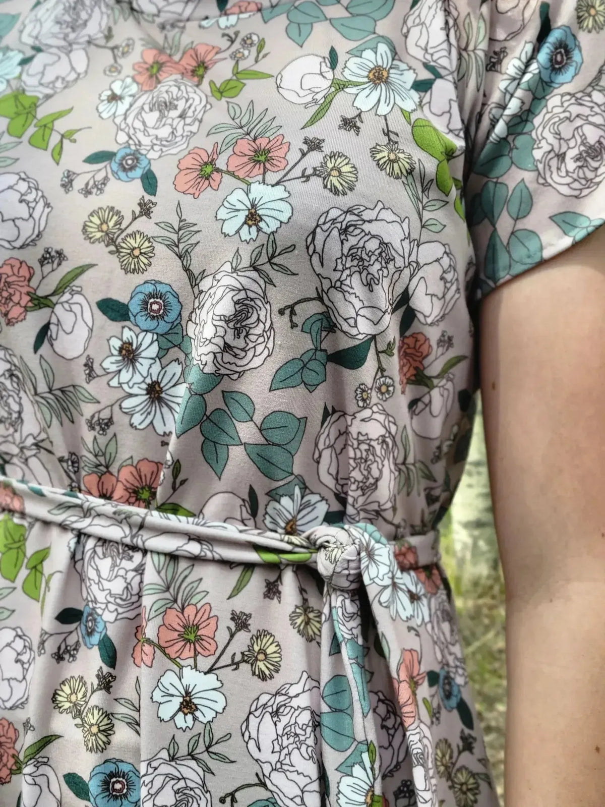 Tan Japanese floral fabric with white, pink, and green flowers on a beige background.