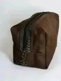 Brown zipper pouch with black trim and gold star charm.