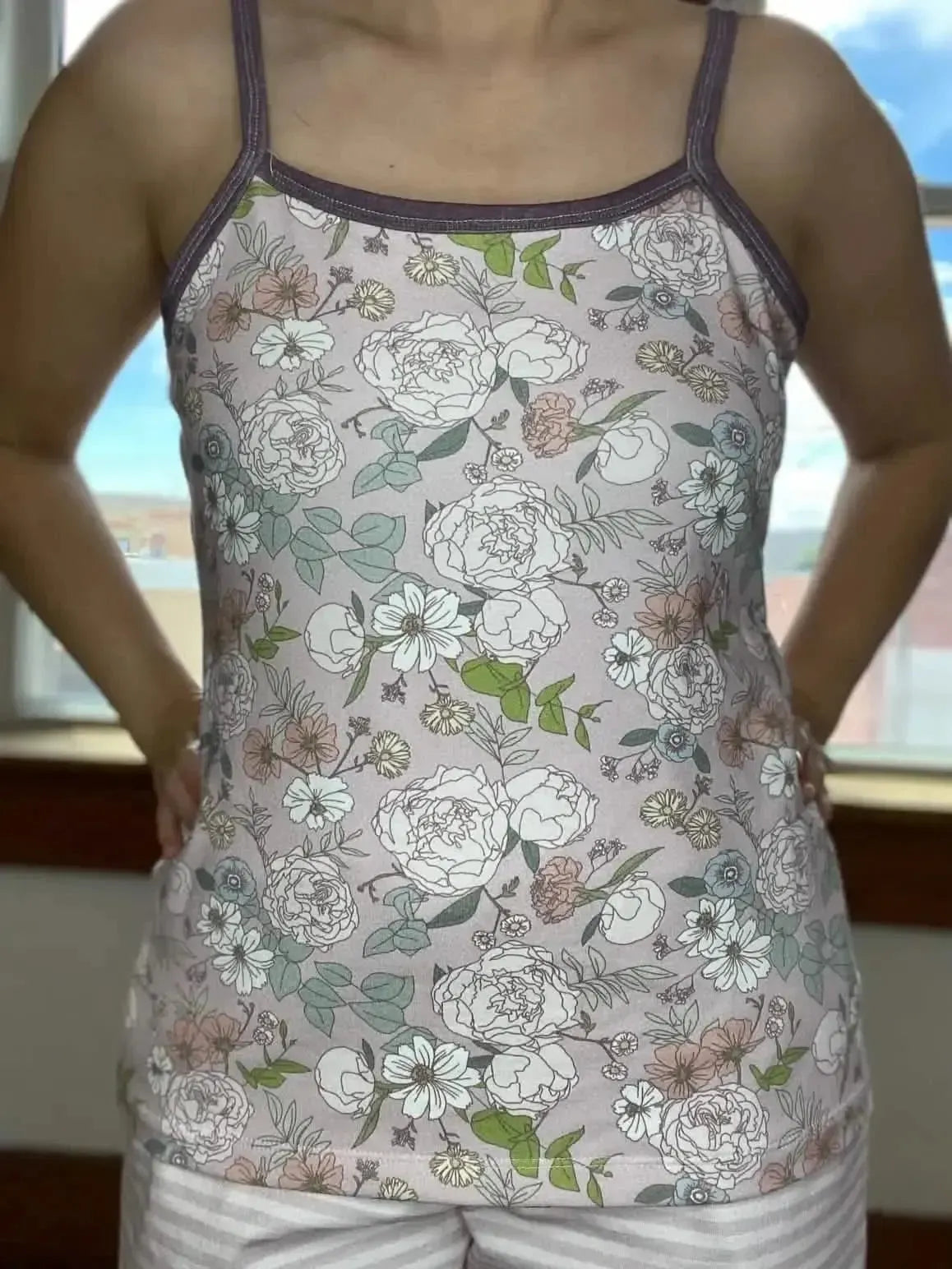 Mauve Japanese floral fabric with pink and white flowers and green leaves.