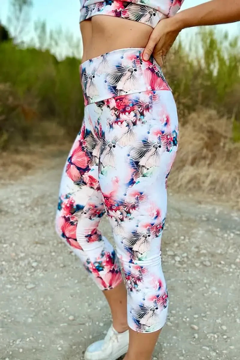 Cropped leggings with a vibrant floral pattern in pink, blue, and white.