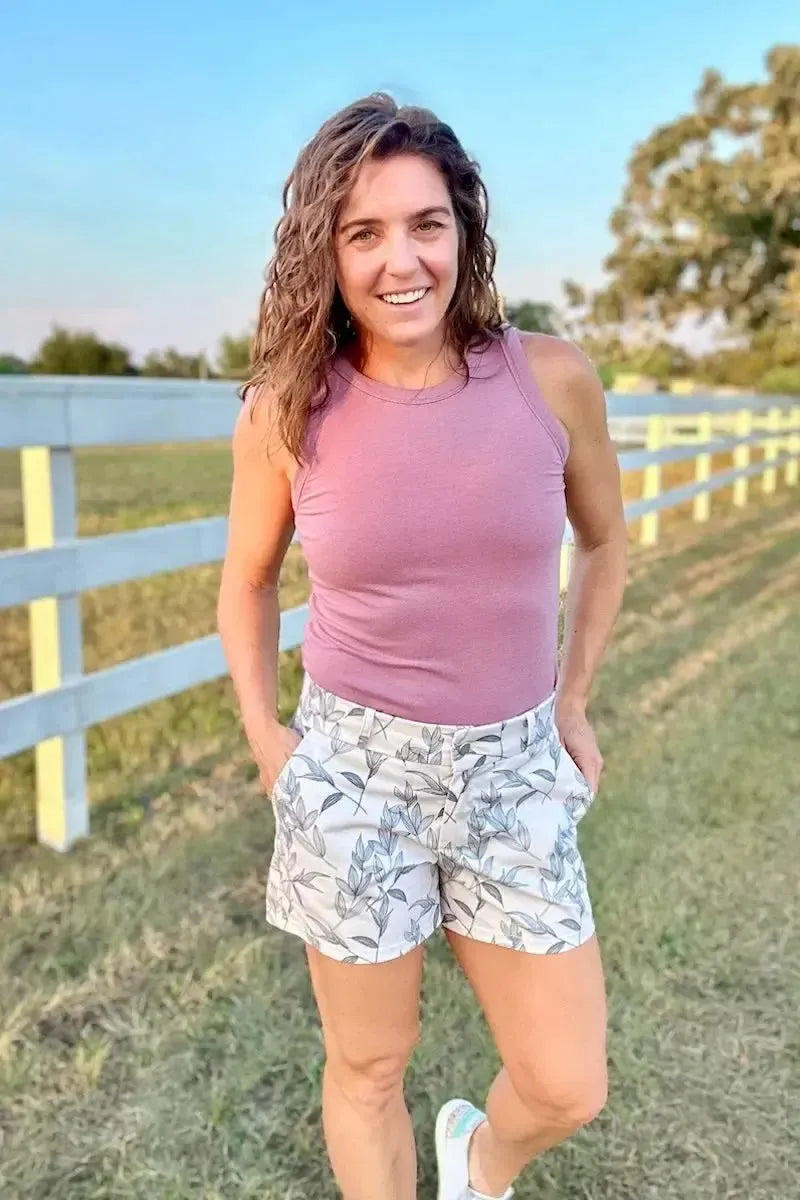 Grey foliage botanical print fabric with leaf patterns on a neutral background.