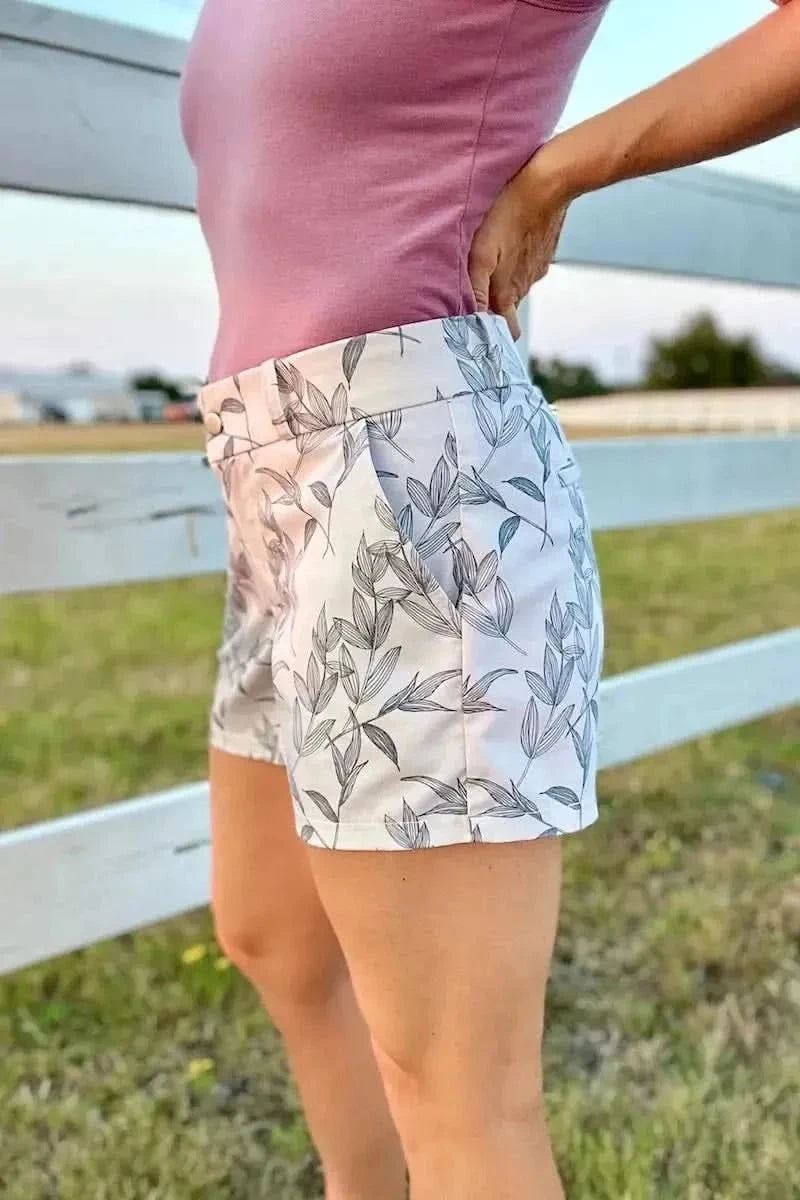 Grey foliage botanical fabric with leaf print on white base.