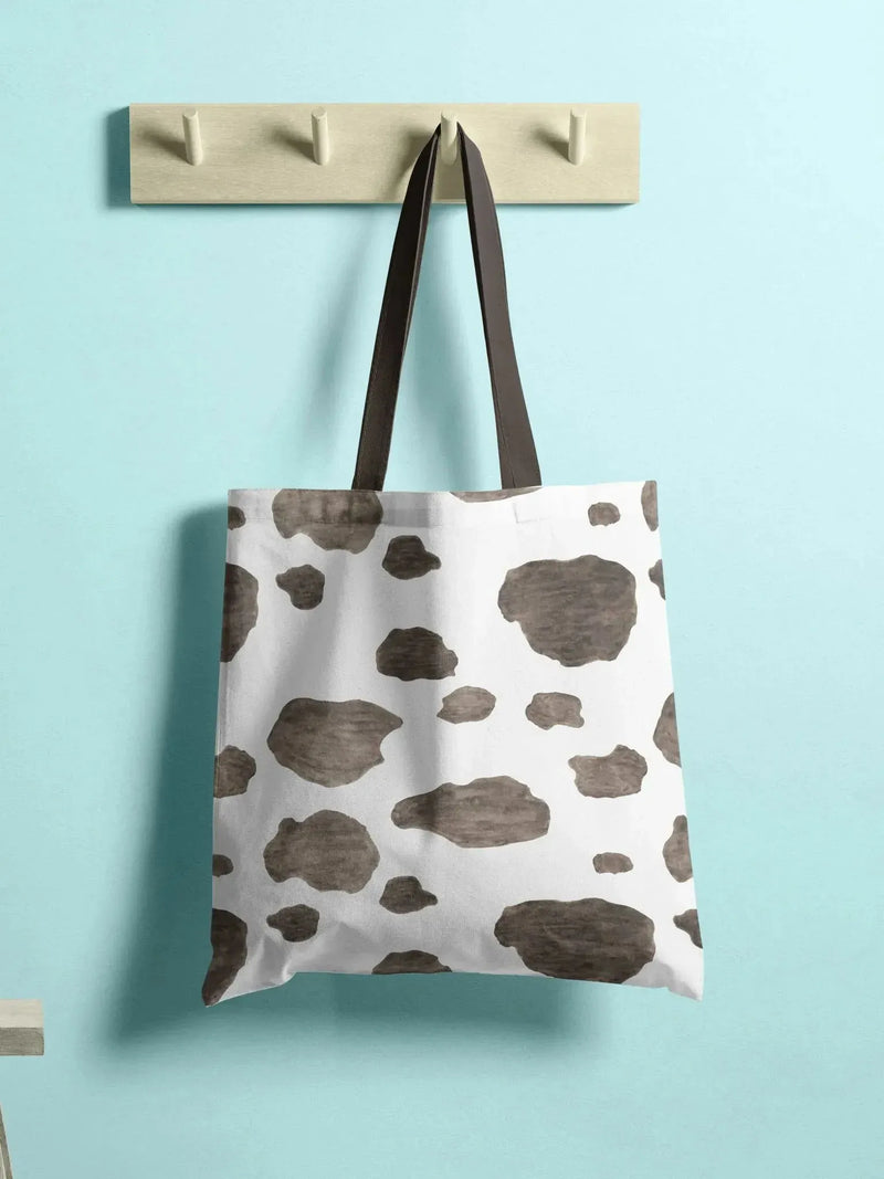 Cowhide print fabric with white base and brown spots animal pattern.