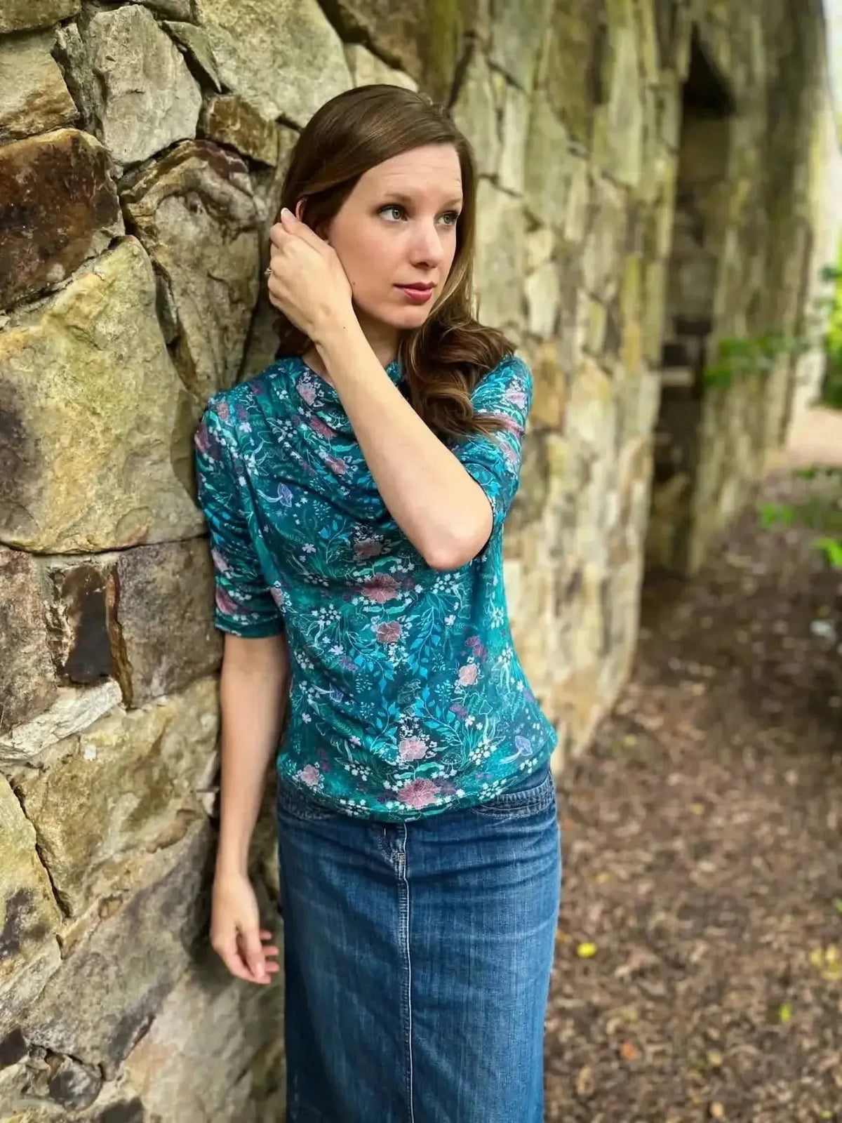 Teal woodland print fabric with enchanted glen pattern on a woman's teal blouse.