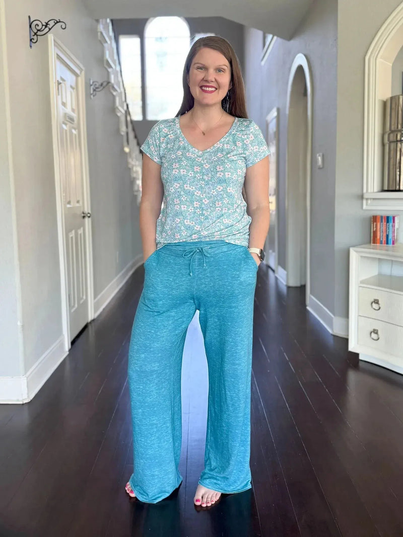 Dark teal heather floral print fabric with small white flowers on a textured background.