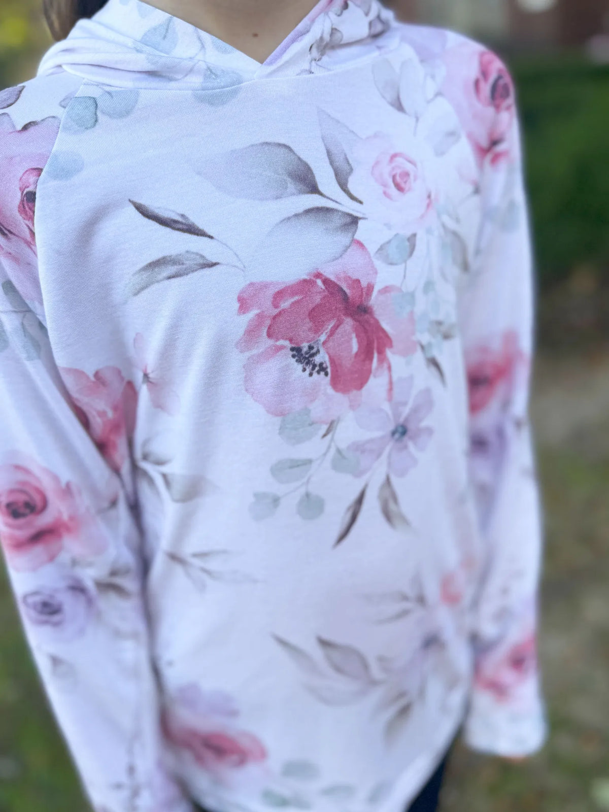 Pink watercolor floral fabric with large blossoms and leaves.