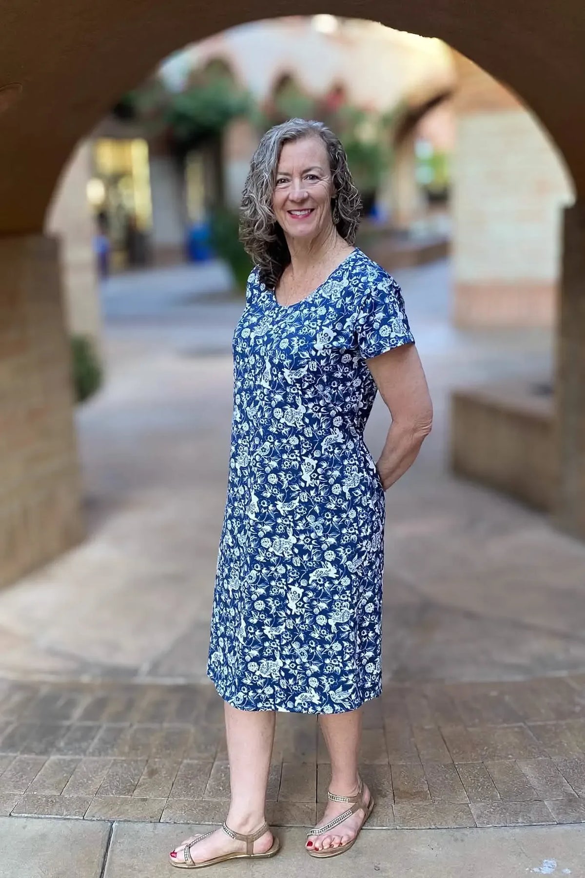 A woman in a blue and white floral dress with a bunny pattern.