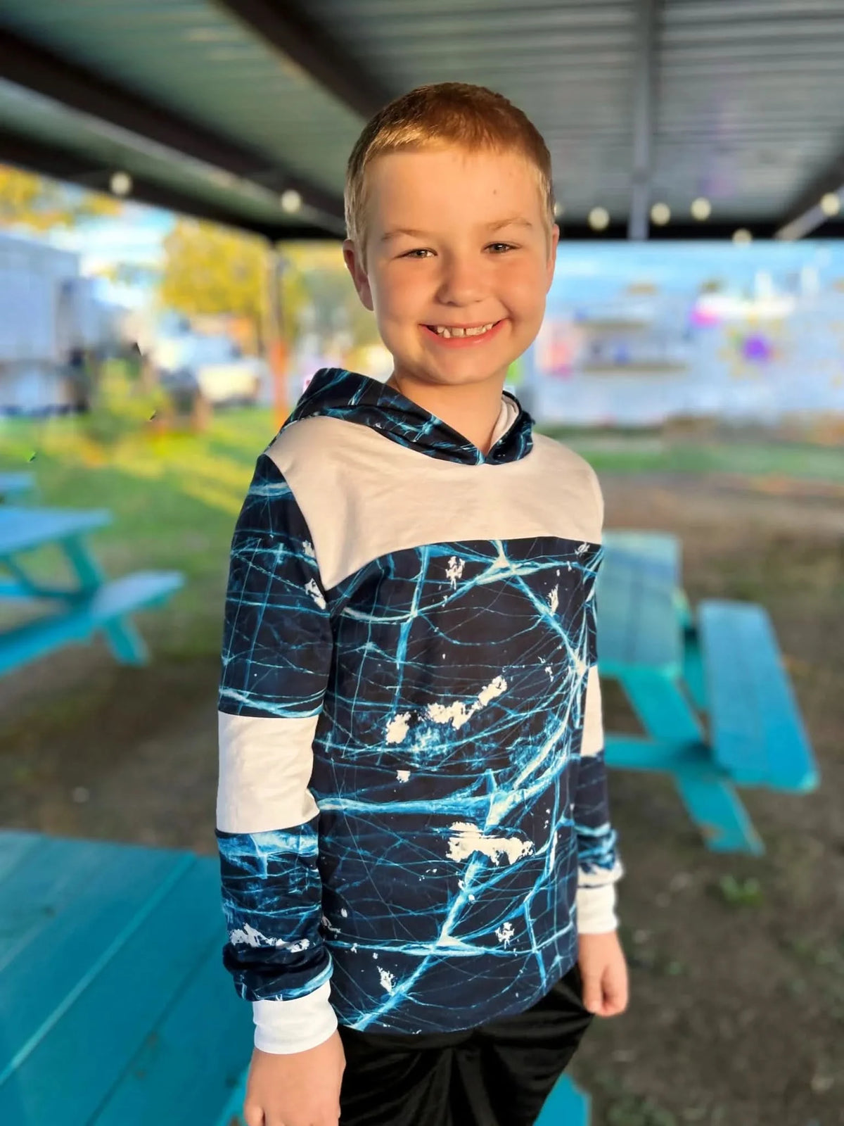 Boy in a navy and white cracked ice hoodie.