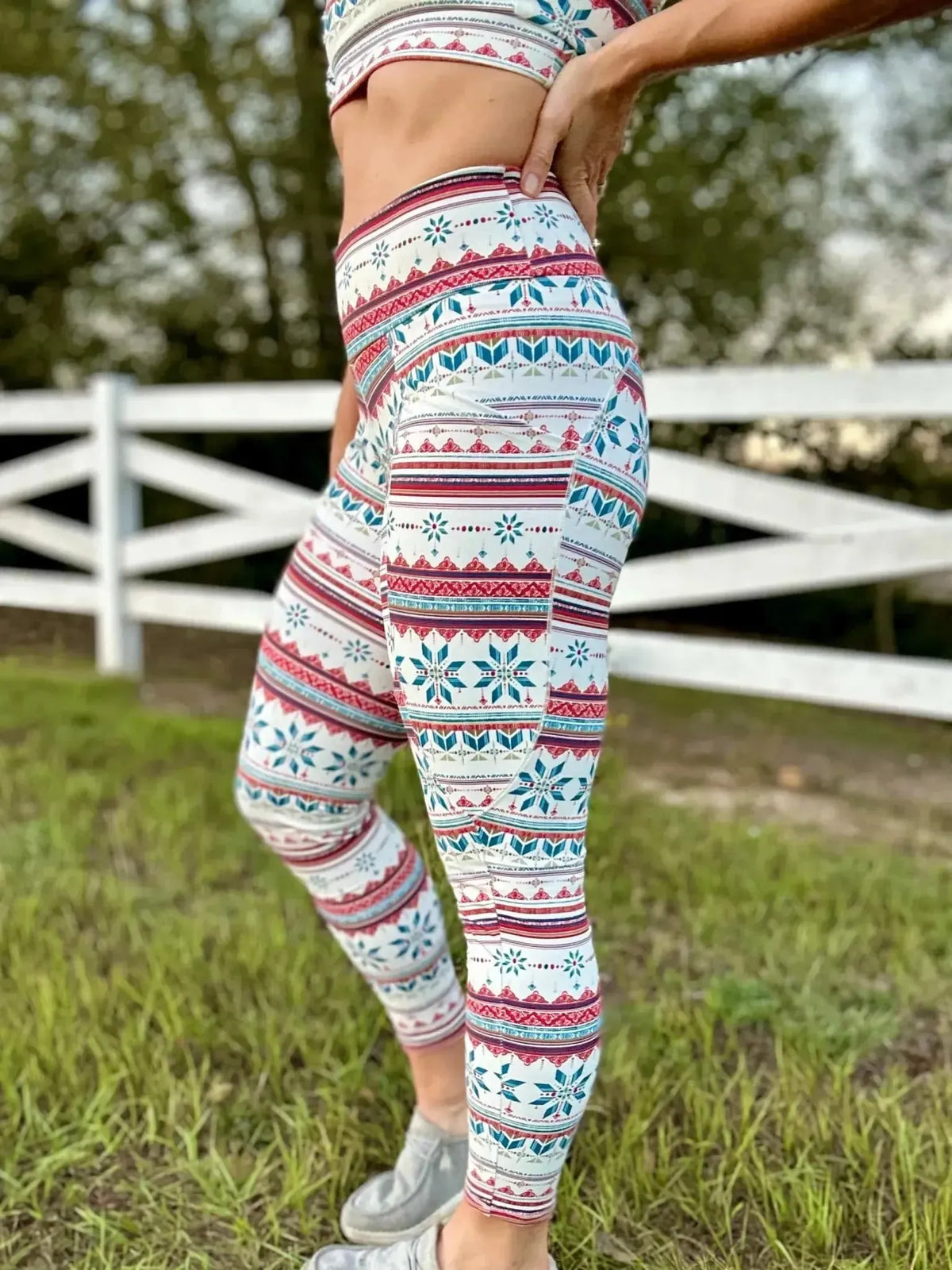 Red and white Fair Isle snowflake print fabric with geometric patterns on a white background.